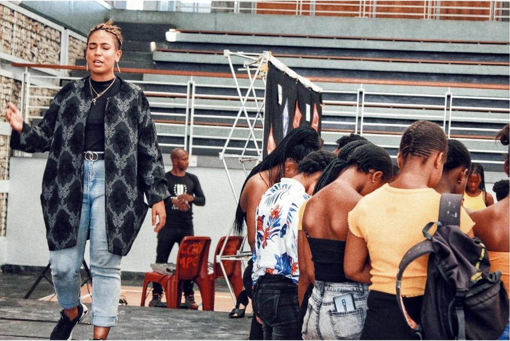 Cleo praying for young girls at Hands of Luv